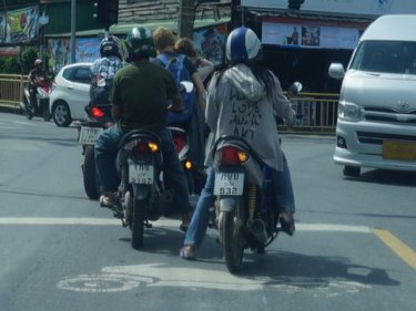 Motorbike riders creep too far forward today and a Western couple decide not to wear helmets: Infringements at three Phuket intersections will be punished