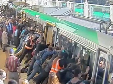 Passengers rock a train to free a man trapped by the leg