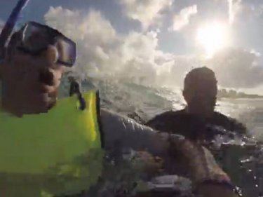 Body surfer Daren Jenner helps the snorkeller back to shore