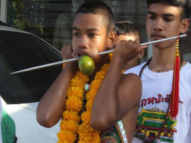 A young possessed parader makes his way through Phuket City today