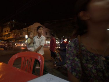 A young beggar with child in Cambodia's capital: grim outlook for refugees