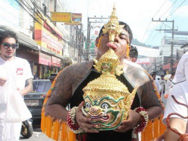 Lick that: a ''warrior'' sacrifices his taste buds in today's Phuket parade