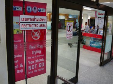 Hidden in an obscure corner at Phuket International Airport, a warning sign that the vast majority of arriving passengers won't get to see
