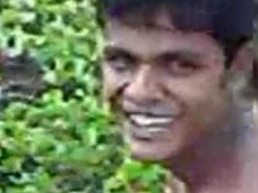 The alleged rapist smiles at the camera while raping a Rohingya woman