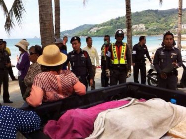 Police clear permanent fixtures from Phuket's Patong beach yesterday