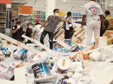 Chaos in store: rescue workers clamber over shelves in Sunday's collapse