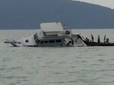 Cruise boat Electric Blue, stuck on a rock off Phuket yesterday