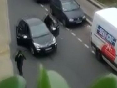 Hooded killers flee in a car in Paris after shooting dead 12 people