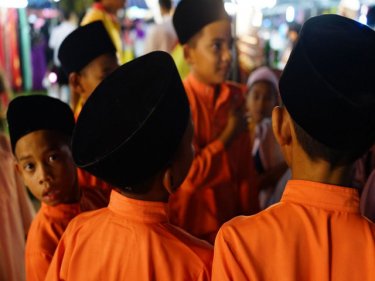 Boys enjoy the fair last night after a Phuket mosque opened yesterday