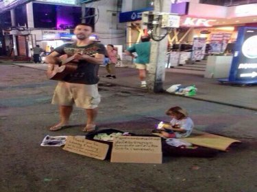 Tourist turned busker Lukas Matena entertains to help his daughter