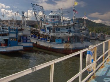 Tightly packed fishing boats cluster in port on Phuket