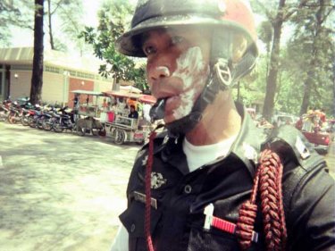 Like it or not, a Patong policeman celebrates Songkran