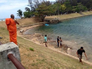 A monk prays for the spirit of a boy, sixth child to drown at a Phuket pond