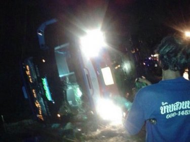 The bus from Phuket on its side after a fatal crash in Krabi last night