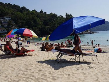 Sunlovers enjoy the relaxation at Phuket's Kata Noi beach