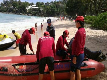 Searchers ready a dinghy at Kata beach on Phuket's west coast today