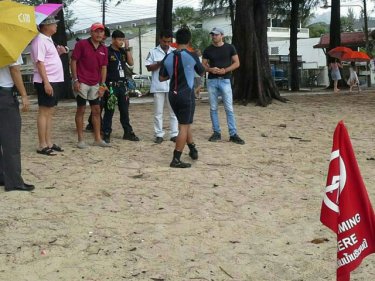 Searchers gather on the beach at Phuket's Kamala