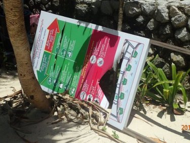 One of the discarded signs promoting the beach rules at Patong