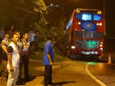A bus slips off Karon Hill tonight but is held safe by a guard rail